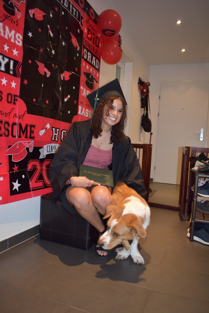 Anna Medina celebrating graduation at home with her dog